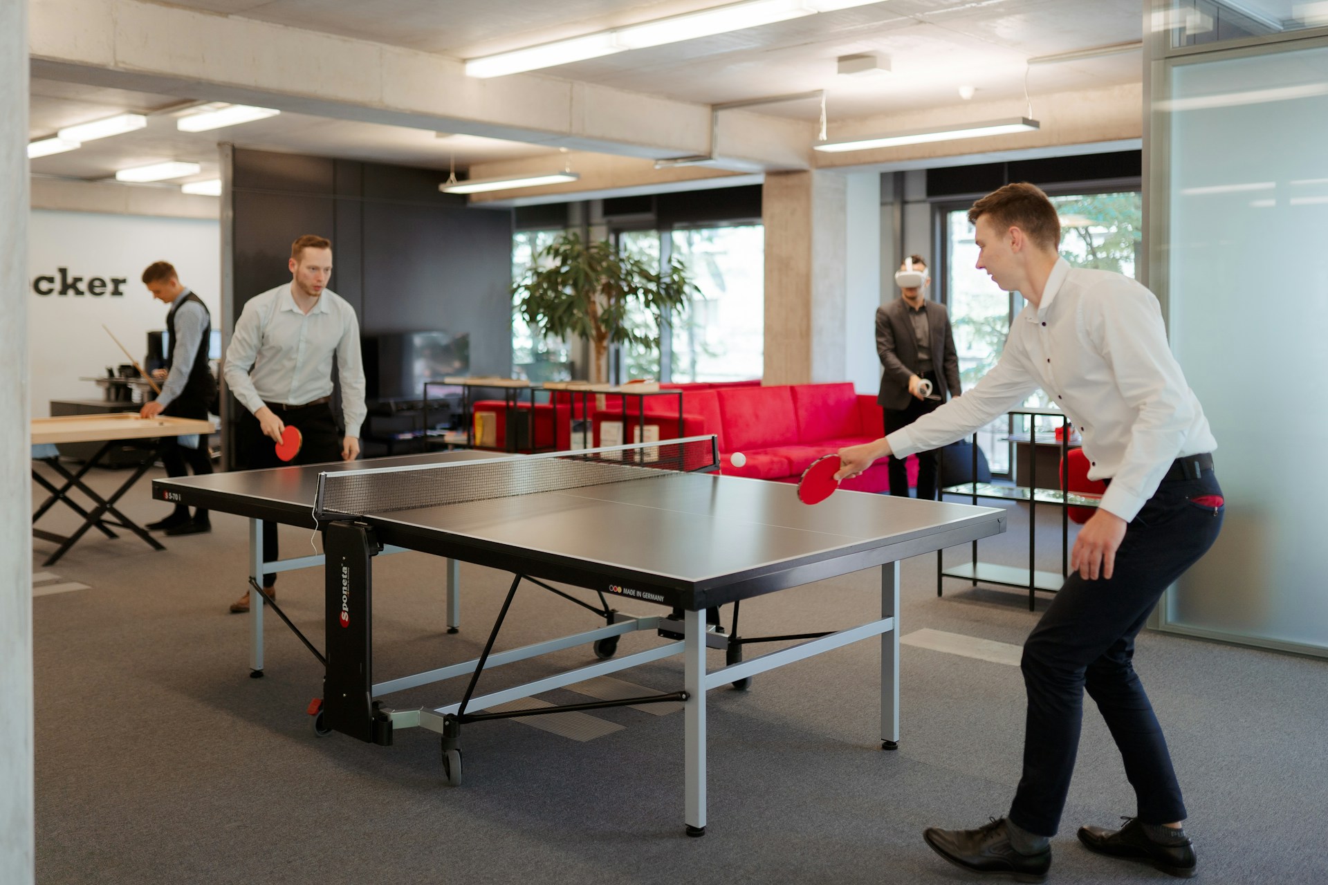 two-business-men-playing-ping-pong-in-an-office-setting
